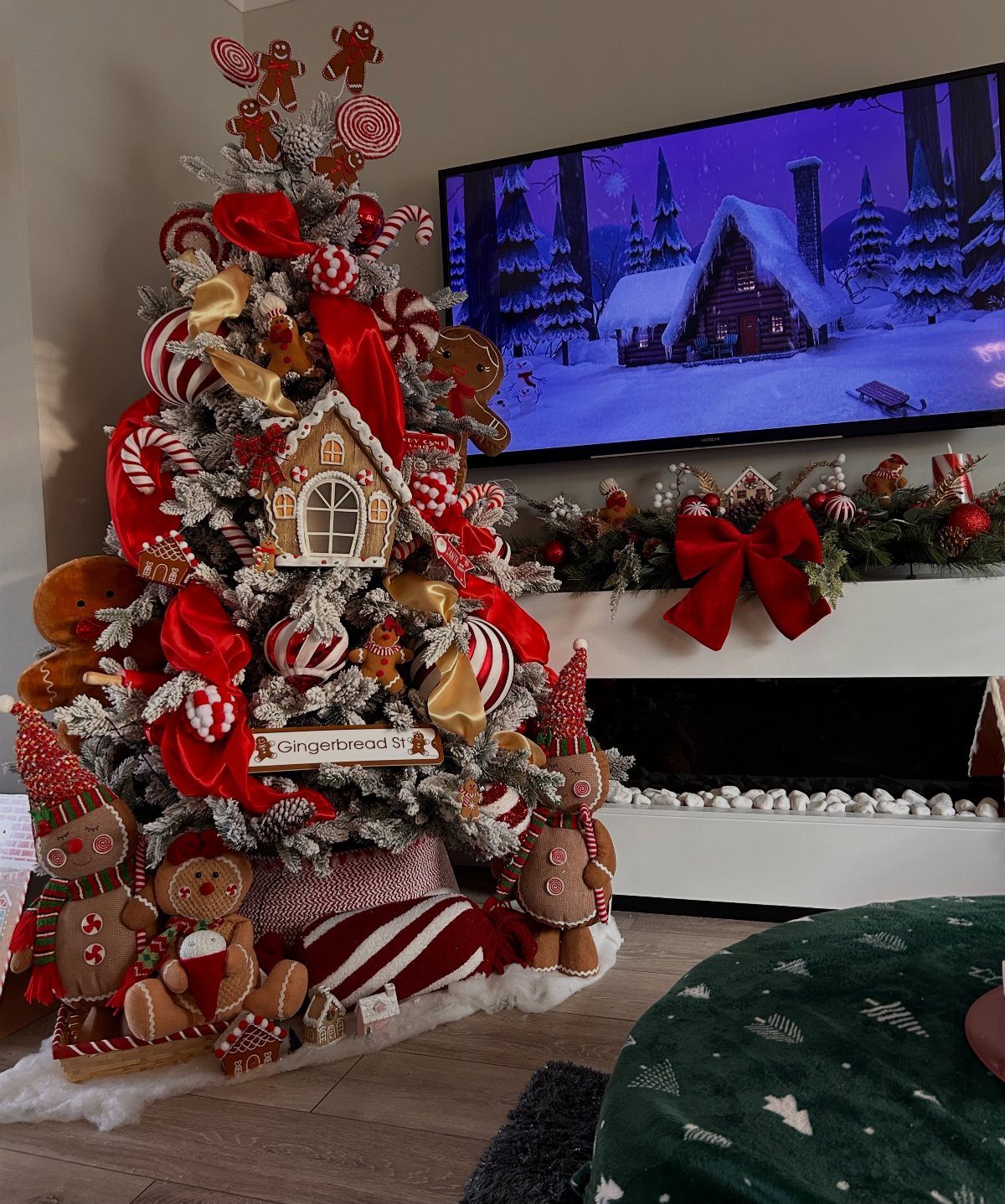 Flocked Christmas tree decorated with gingerbread men, candy canes, and red ribbons.