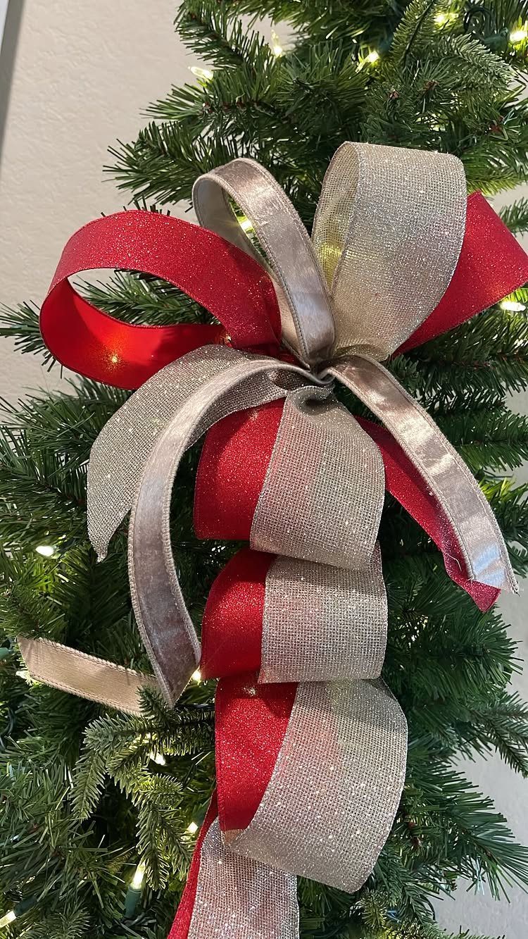 Red and silver shimmering ribbons tied in a bow on a Christmas tree