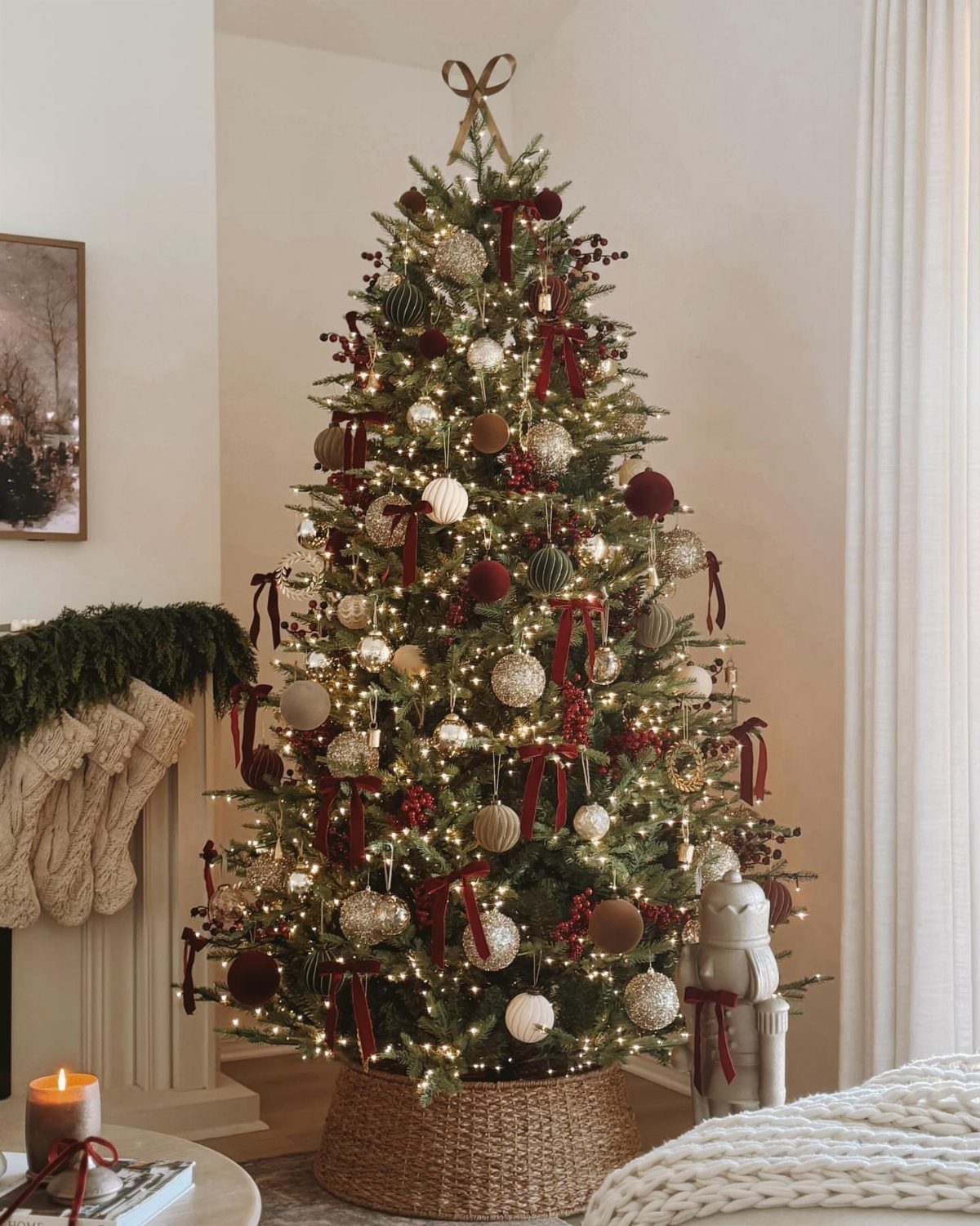 Christmas tree decorated with red velvet bows, gold ornaments, and warm white lights.