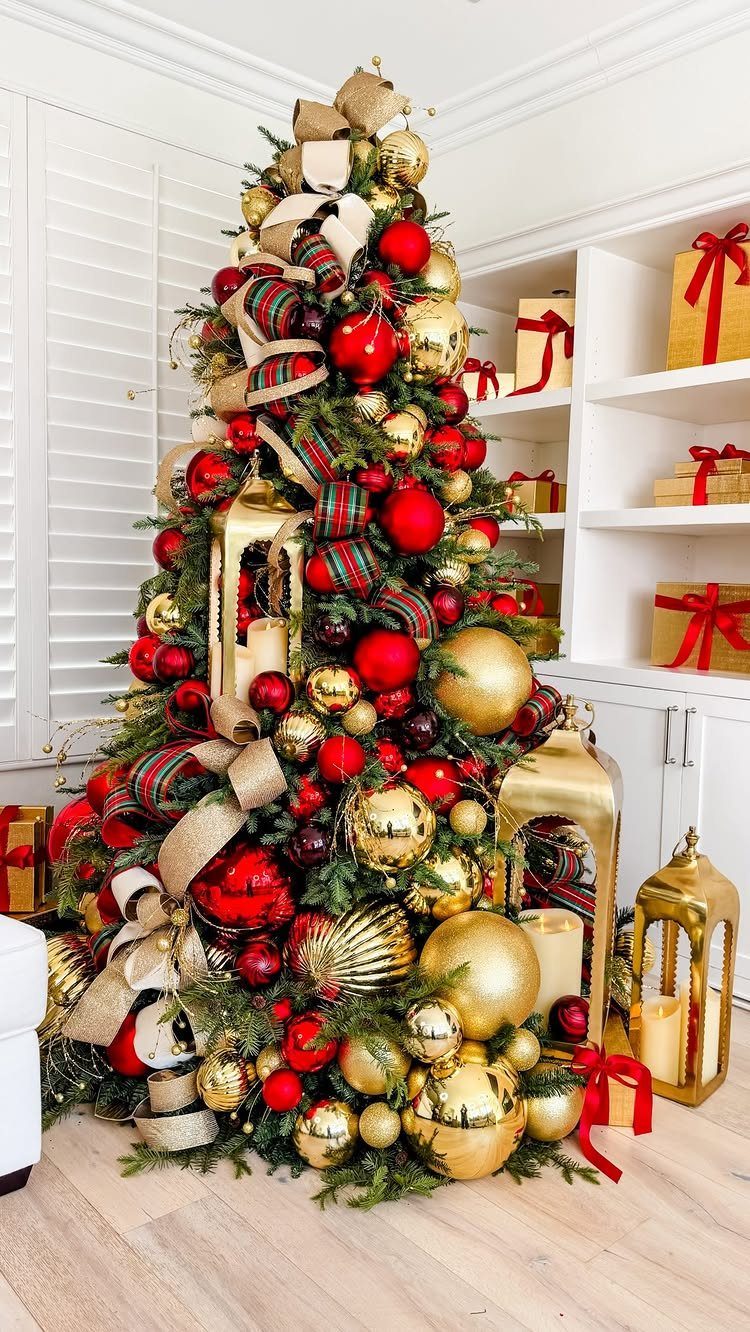 Decorated Christmas tree with red and gold ornaments and wide plaid ribbons.