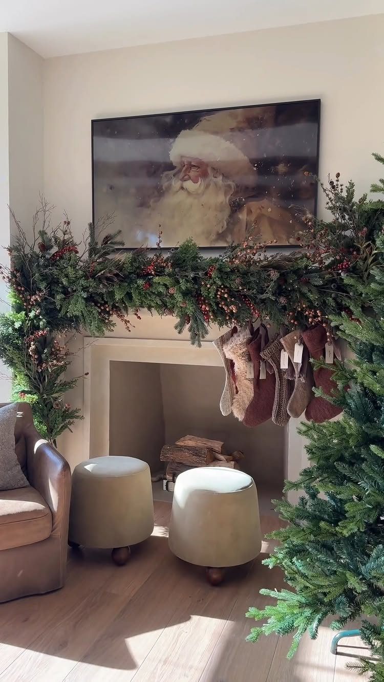 Christmas stockings hanging from a fireplace mantel decorated with evergreen garland and berries.
