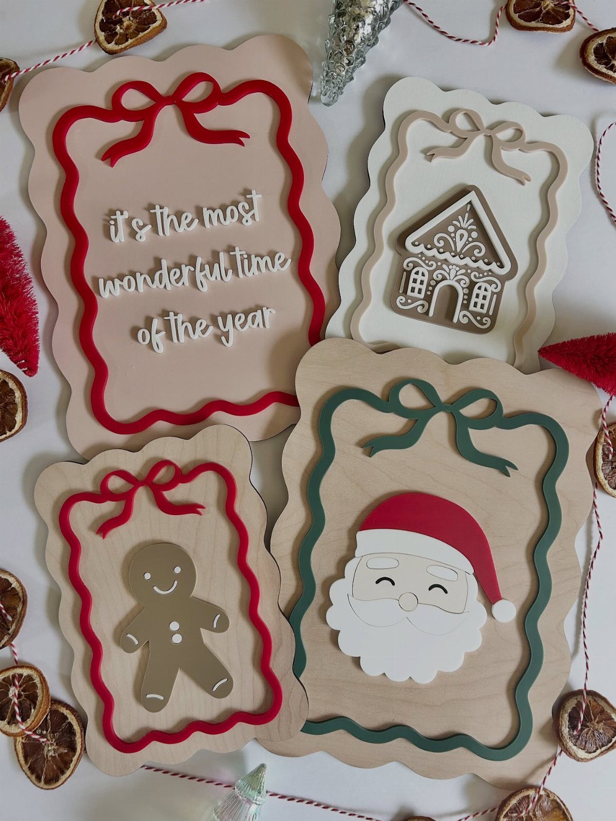 Wooden Christmas signs featuring Santa, a gingerbread man, and festive holiday quotes.