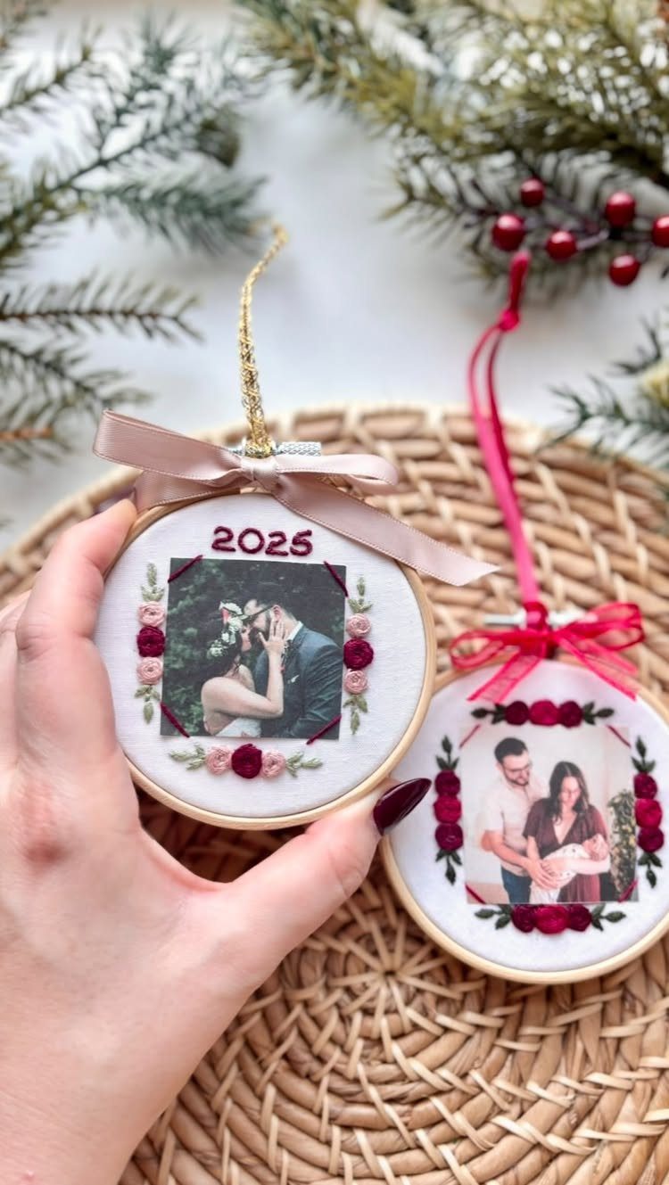 Two circular embroidery hoop ornaments featuring personal photographs and small fabric flowers.