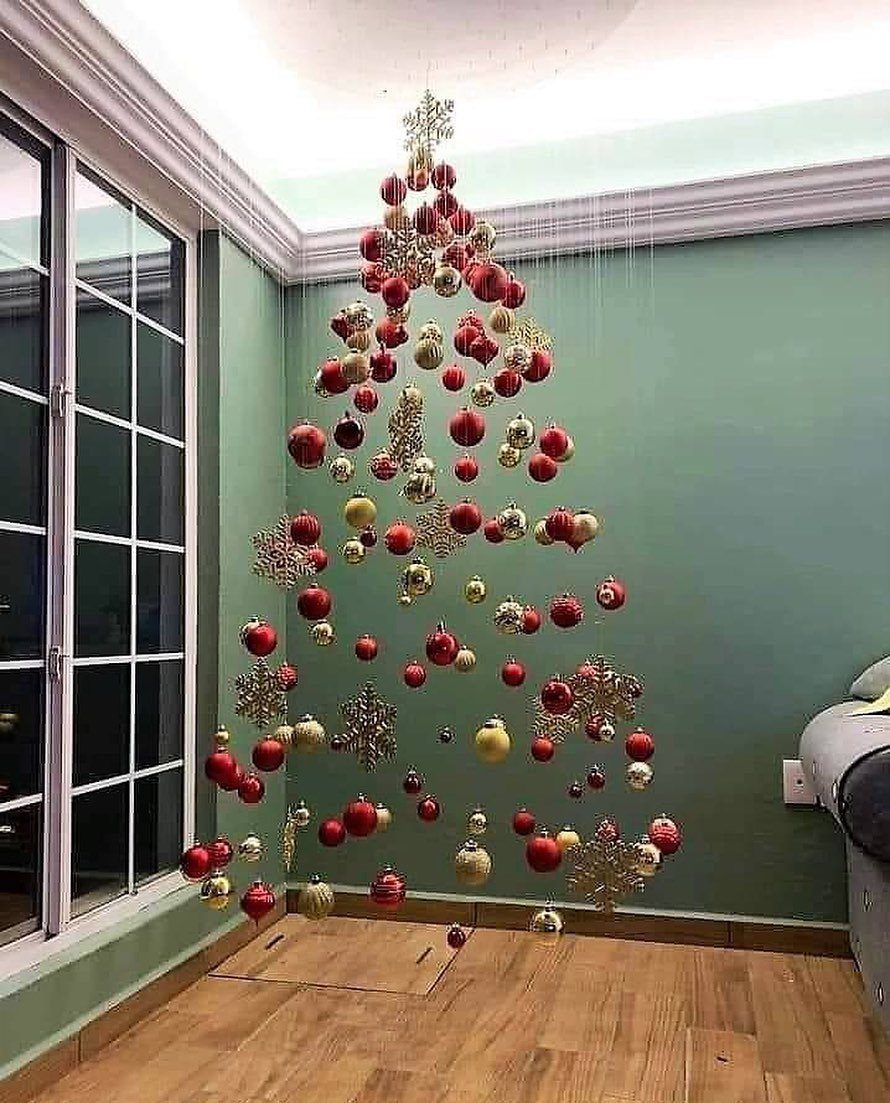 Christmas ornaments and snowflakes hanging from a ceiling in a tree shape
