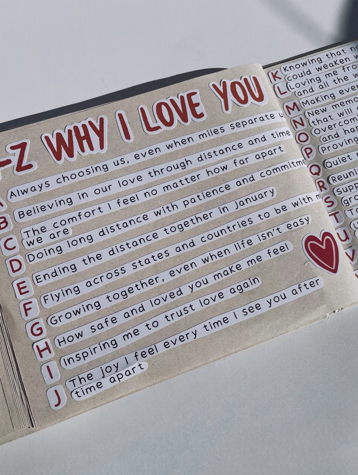 Handmade A-Z why I love you card with written reasons and red heart.
