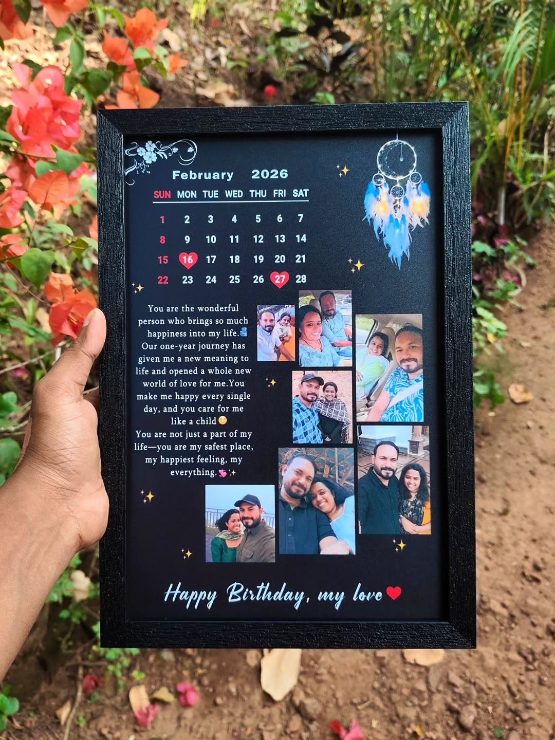 Personalized black framed calendar with photos and romantic message held by a hand.