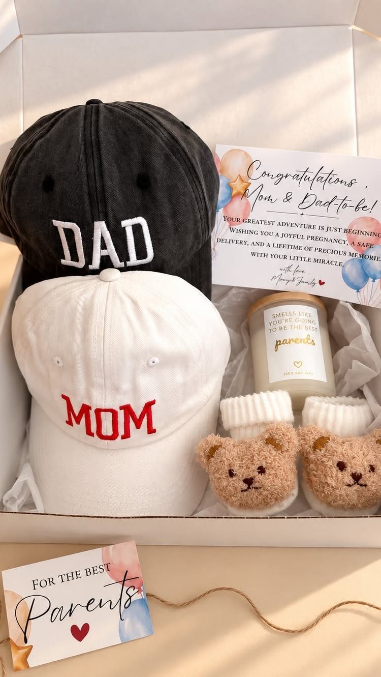 Gift box with Mom and Dad caps, baby booties, and a congratulations card.