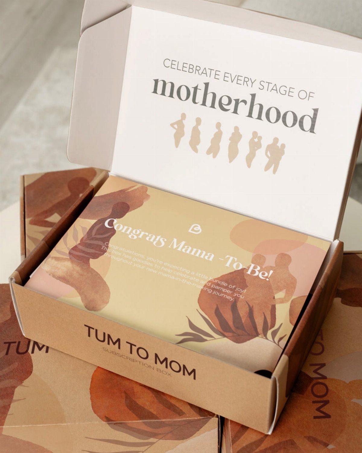 Open Tum to Mom subscription box with a congratulatory card for expecting mothers.