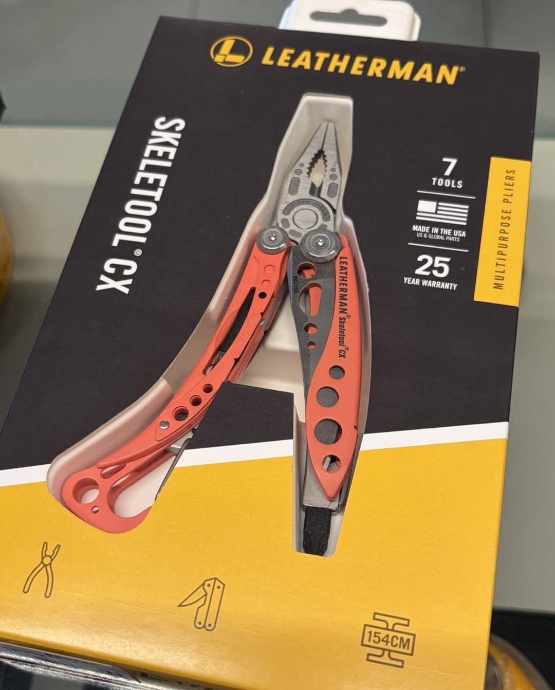 Leatherman Skeletool CX multi-tool with red handles in its original retail packaging.