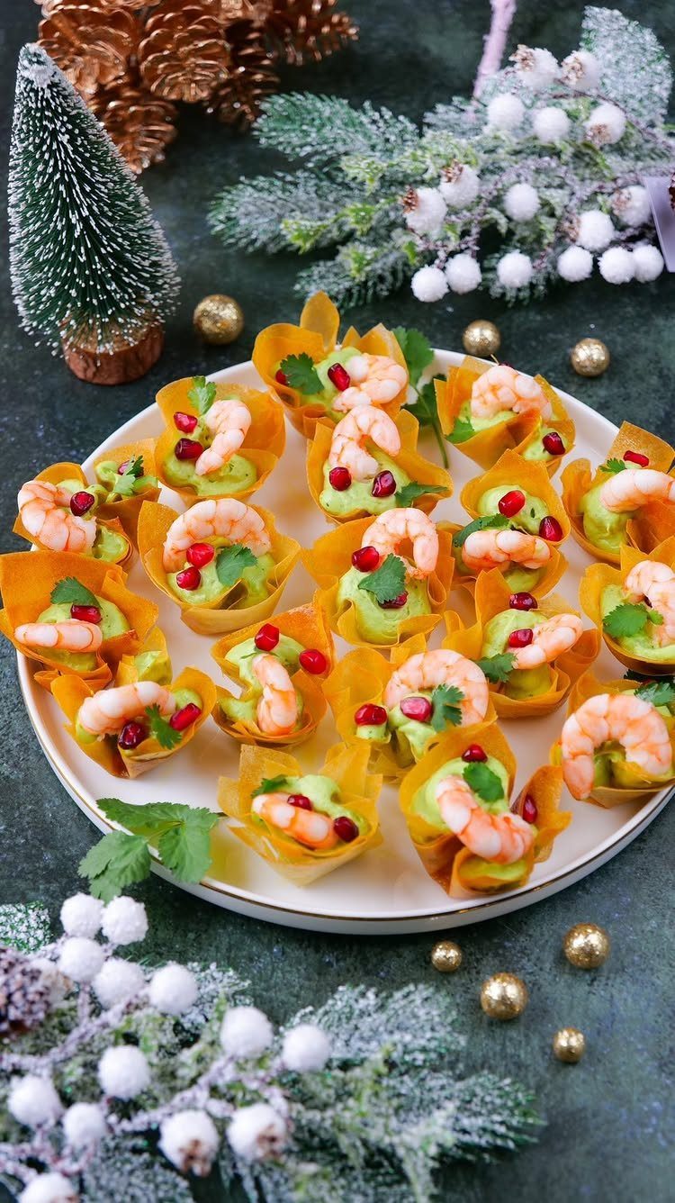 Shrimp and avocado mousse appetizers in pastry cups on a festive holiday platter.