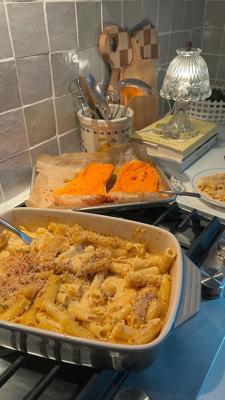 Creamy butternut squash pasta in a baking dish with roasted squash in background