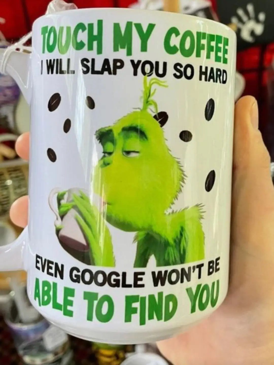 White coffee mug with the Grinch and a funny warning about touching coffee.