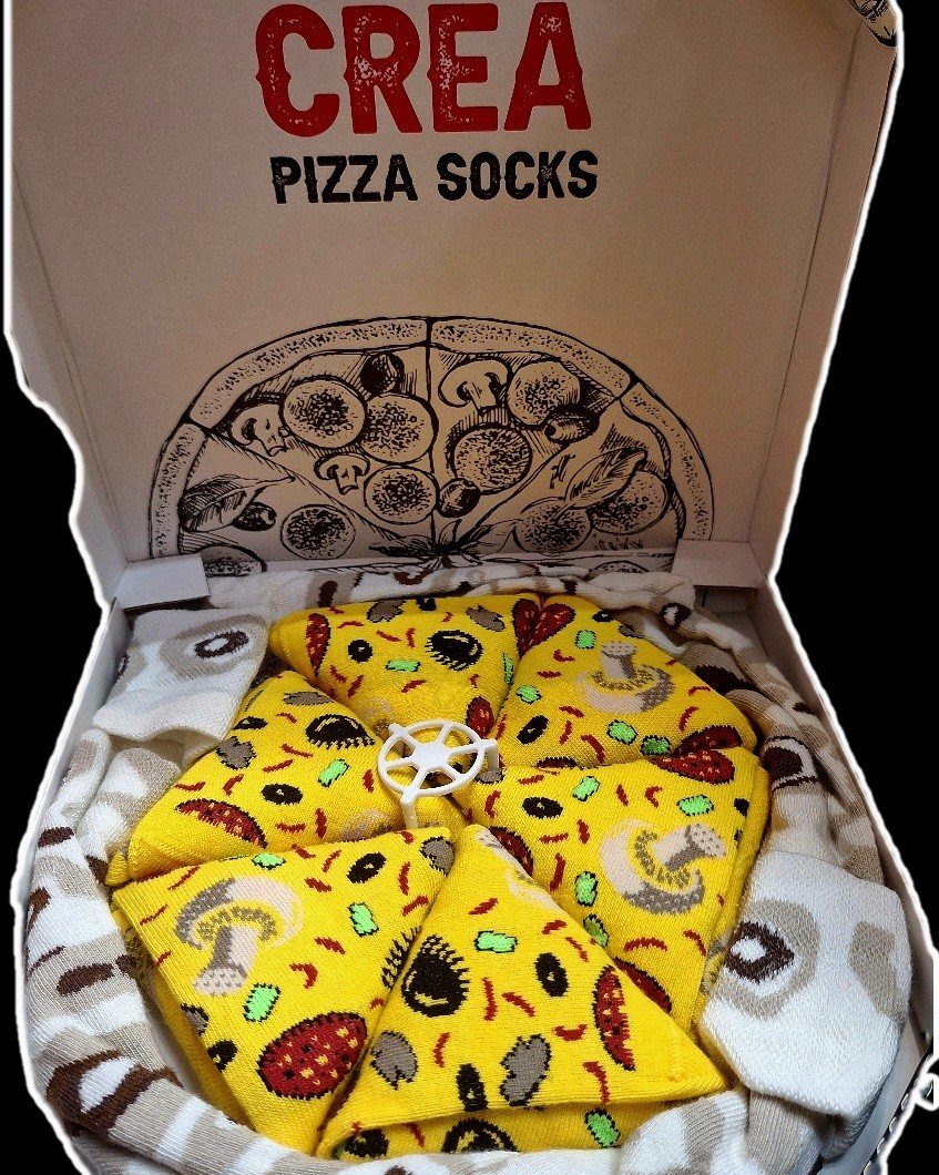 Pizza-patterned socks folded into slices inside a white pizza box.