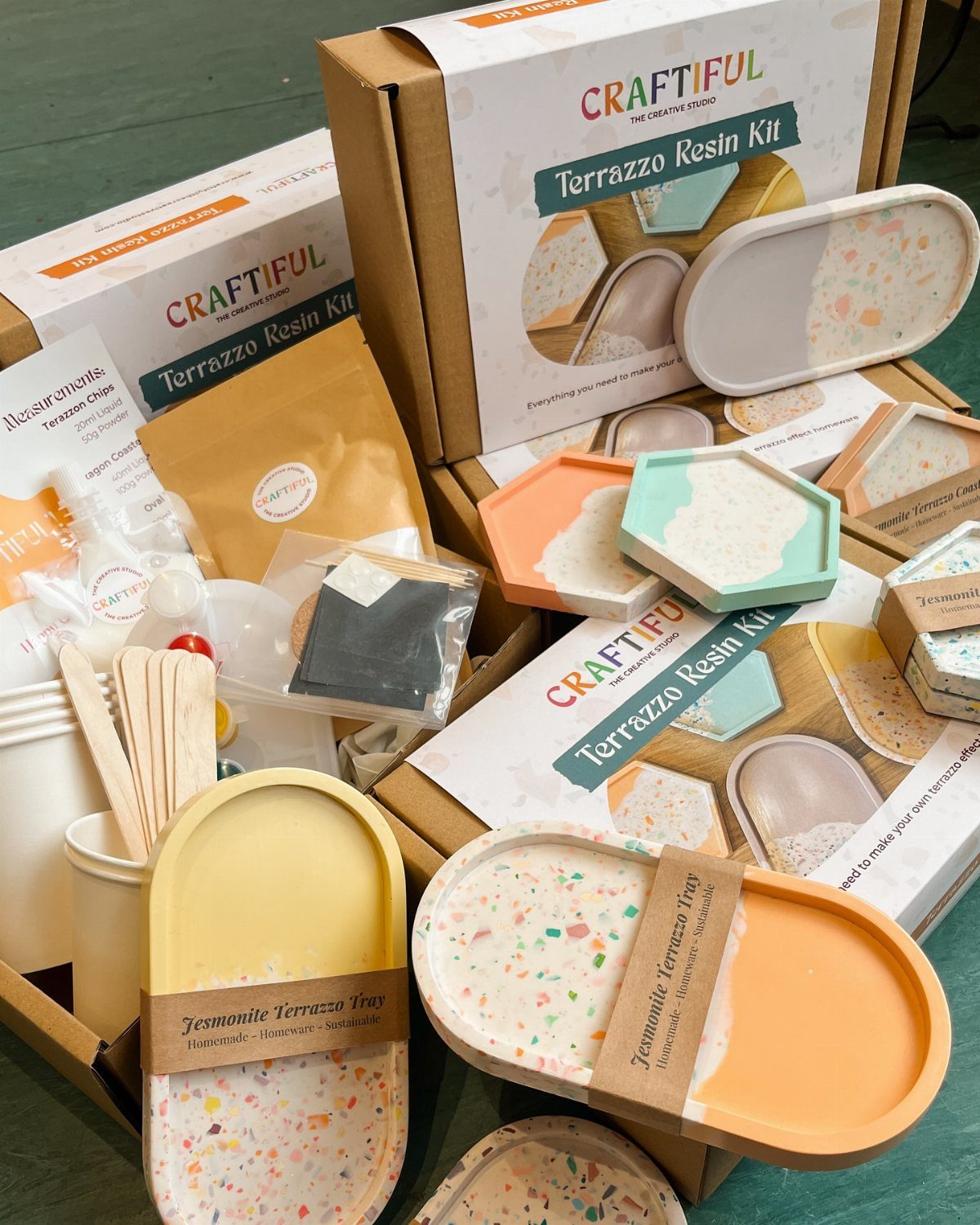 Terrazzo Resin Kit with crafting materials and finished colorful speckled resin trays.