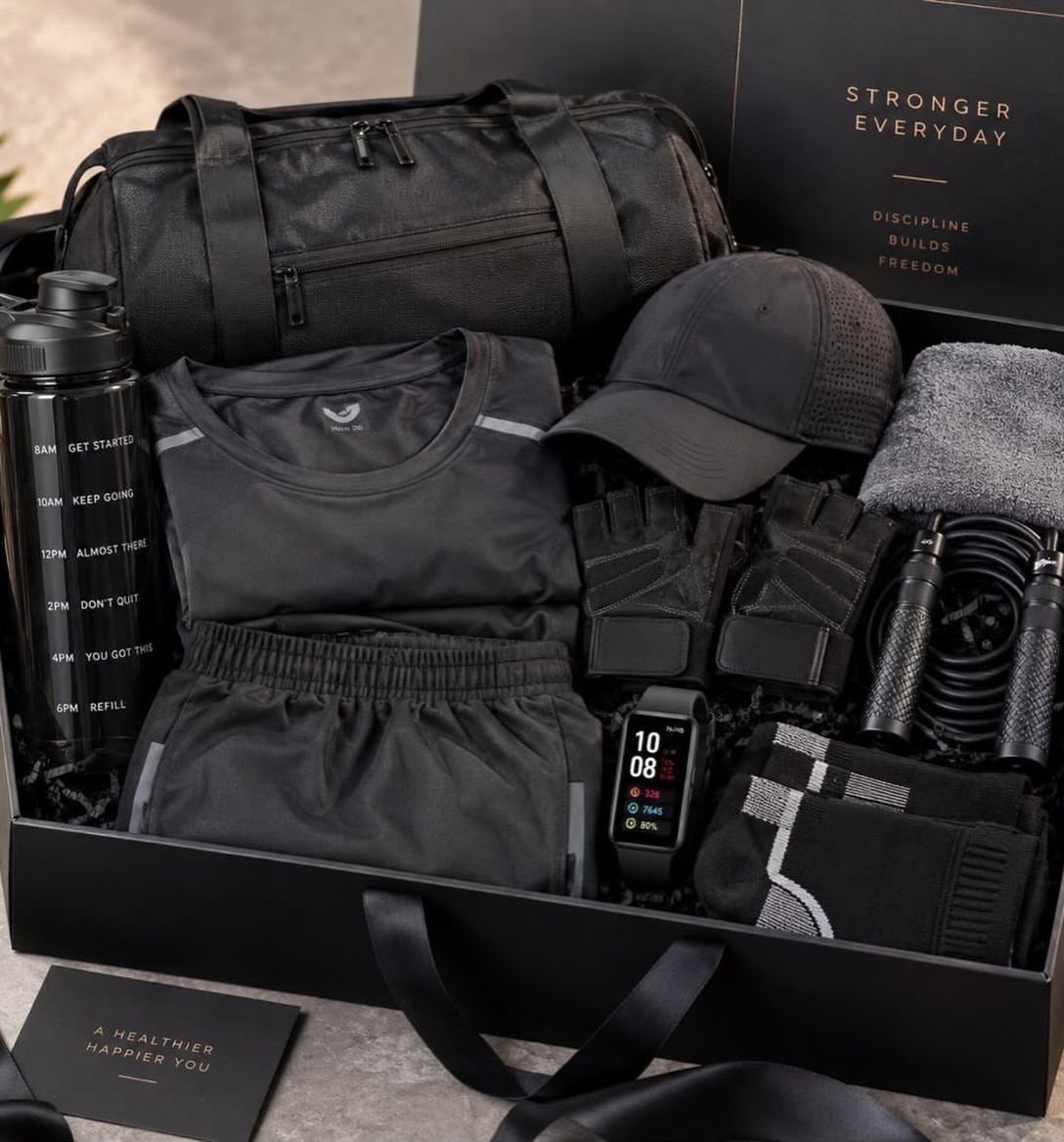 Fitness gift set in a black box with gym clothes and workout accessories.