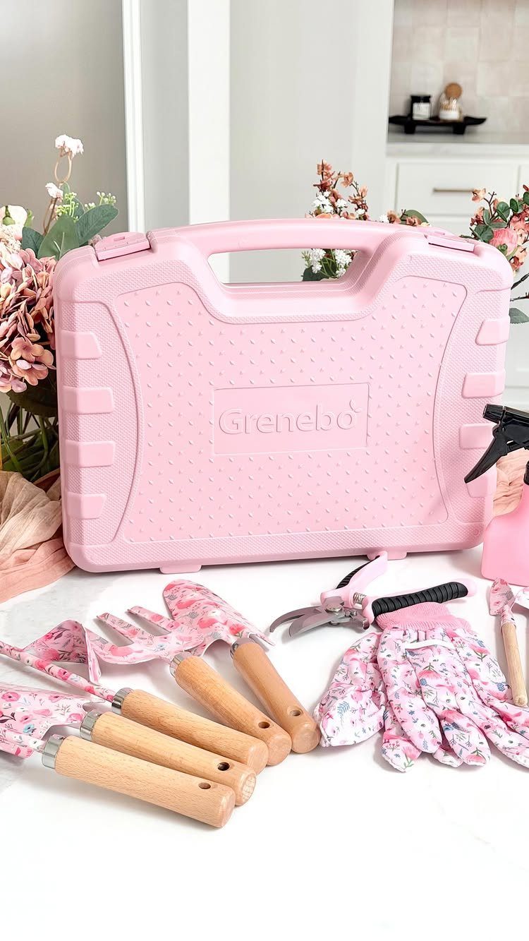 Pink gardening tool set with wooden handles, floral gloves, and a matching carrying case.