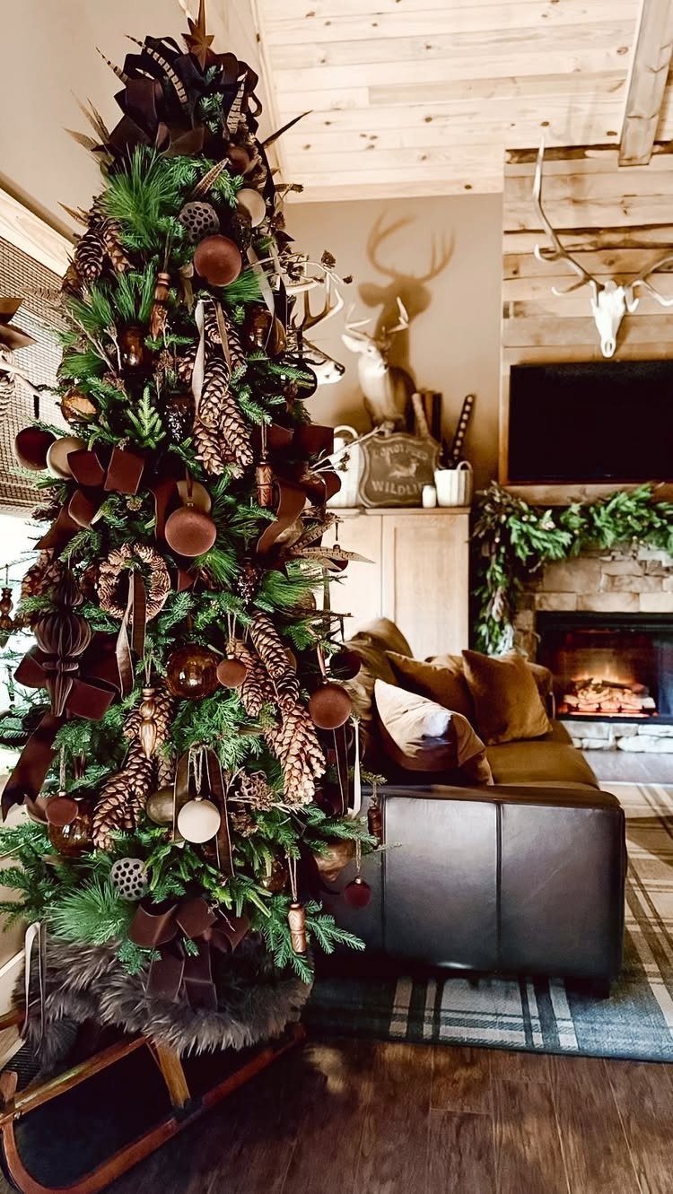 Decorated Christmas tree with brown ribbons and pinecones in a rustic living room.