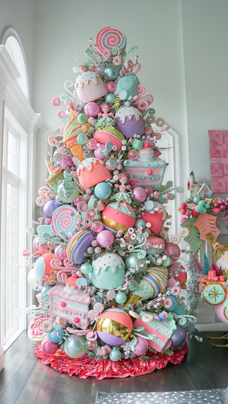Candy-themed Christmas tree with oversized pastel cupcakes, macarons, and lollipops ornaments.