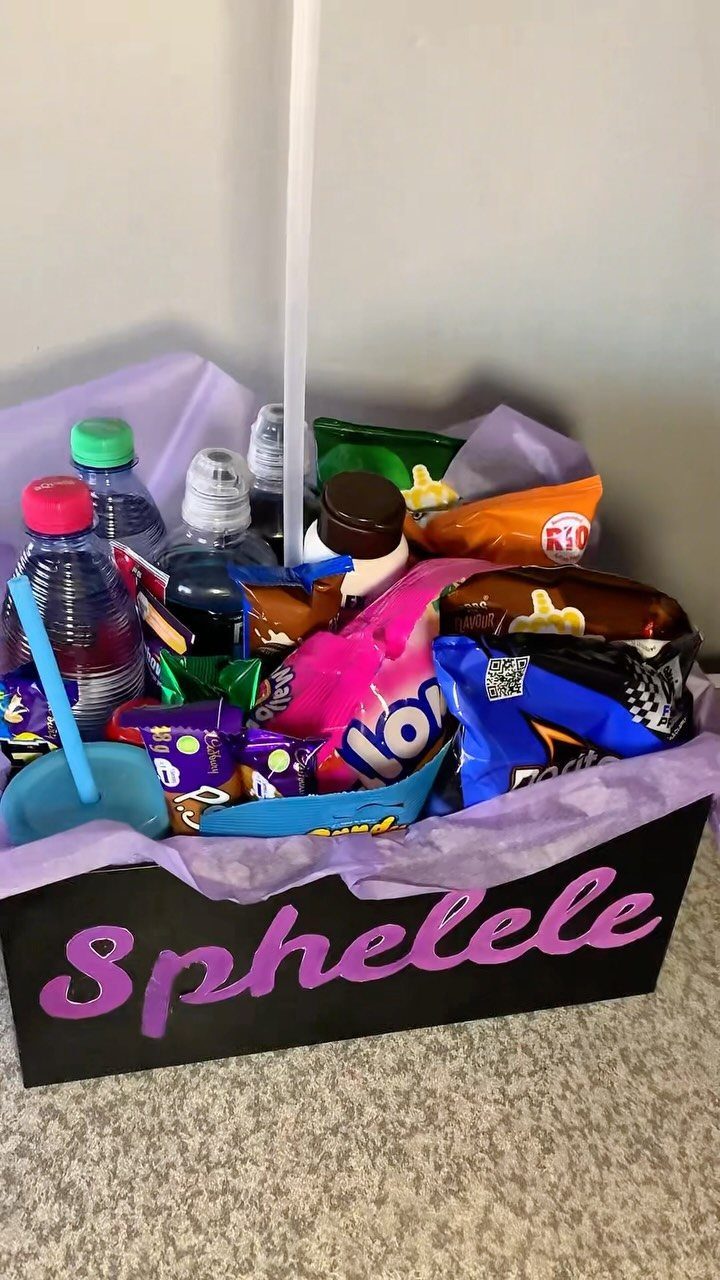 Black gift crate filled with snacks and water, labeled Sphelele in purple letters.