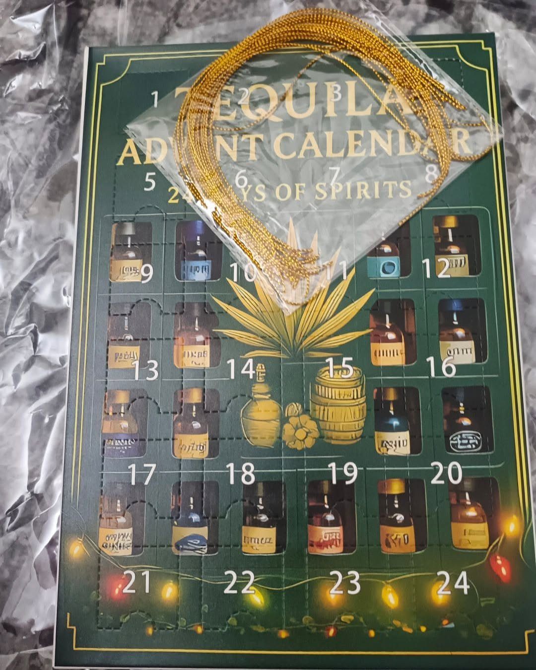 Tequila Advent Calendar box with numbered spirit bottles and a gold cord.