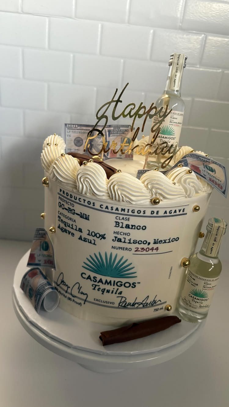 Birthday cake decorated with Casamigos Tequila branding, mini tequila bottles, and toy money.