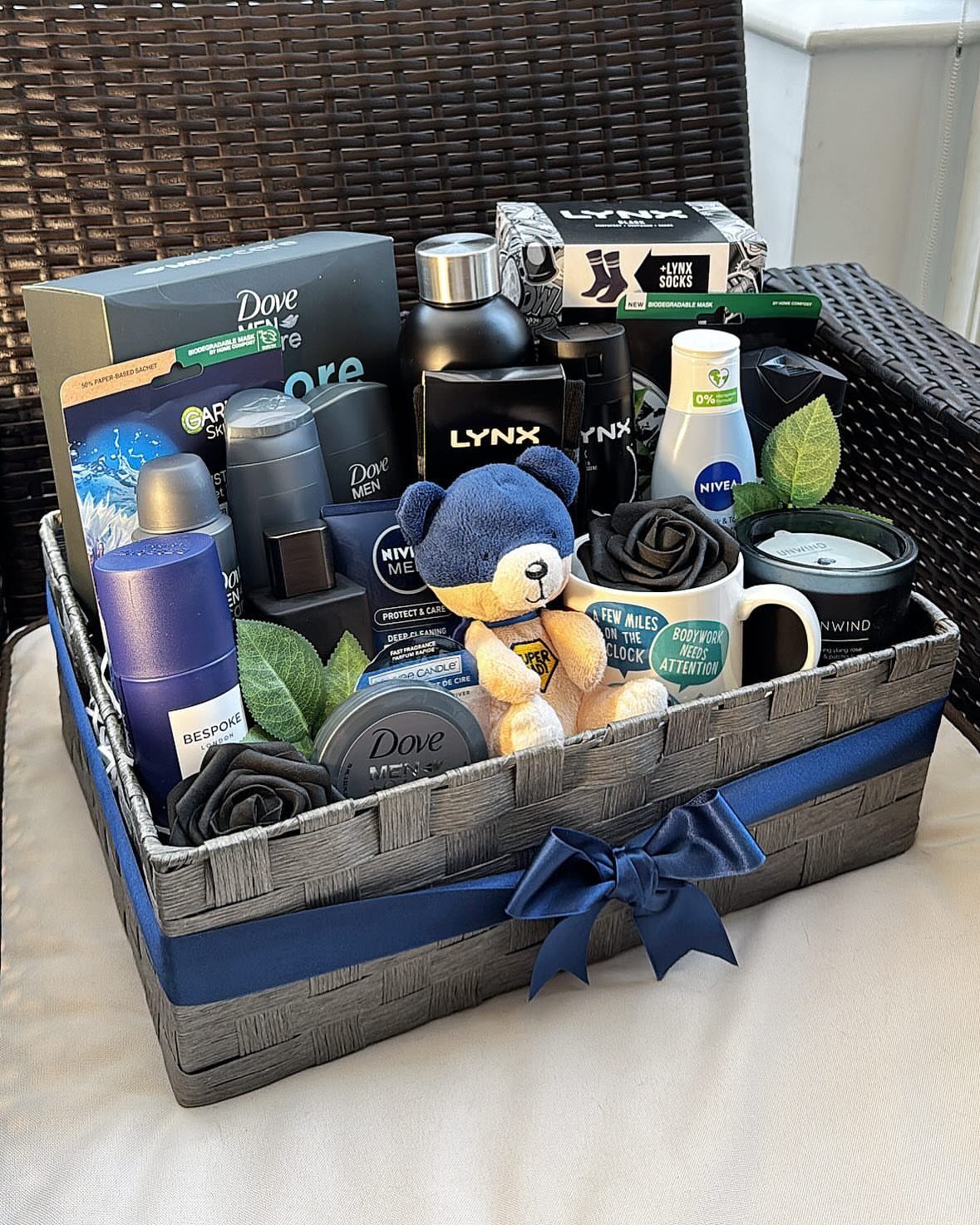 Men's grooming gift basket with toiletries, a blue teddy bear, and a mug.