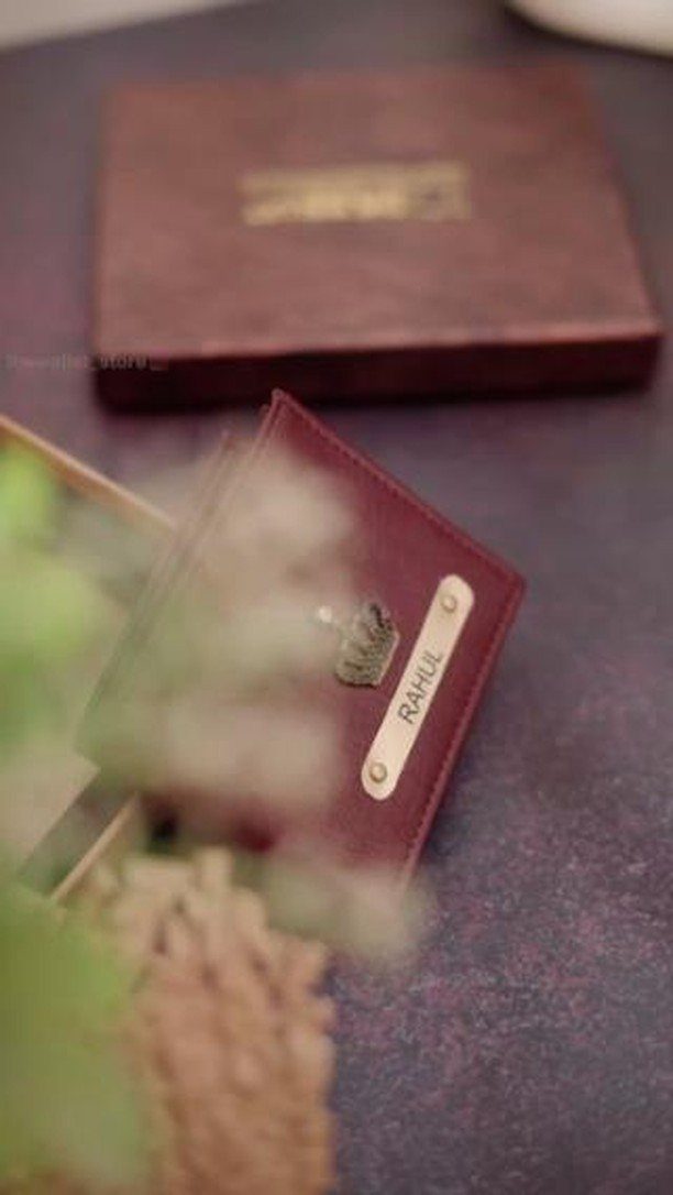 Brown leather wallet with a personalized metal nameplate engraved with Rahul