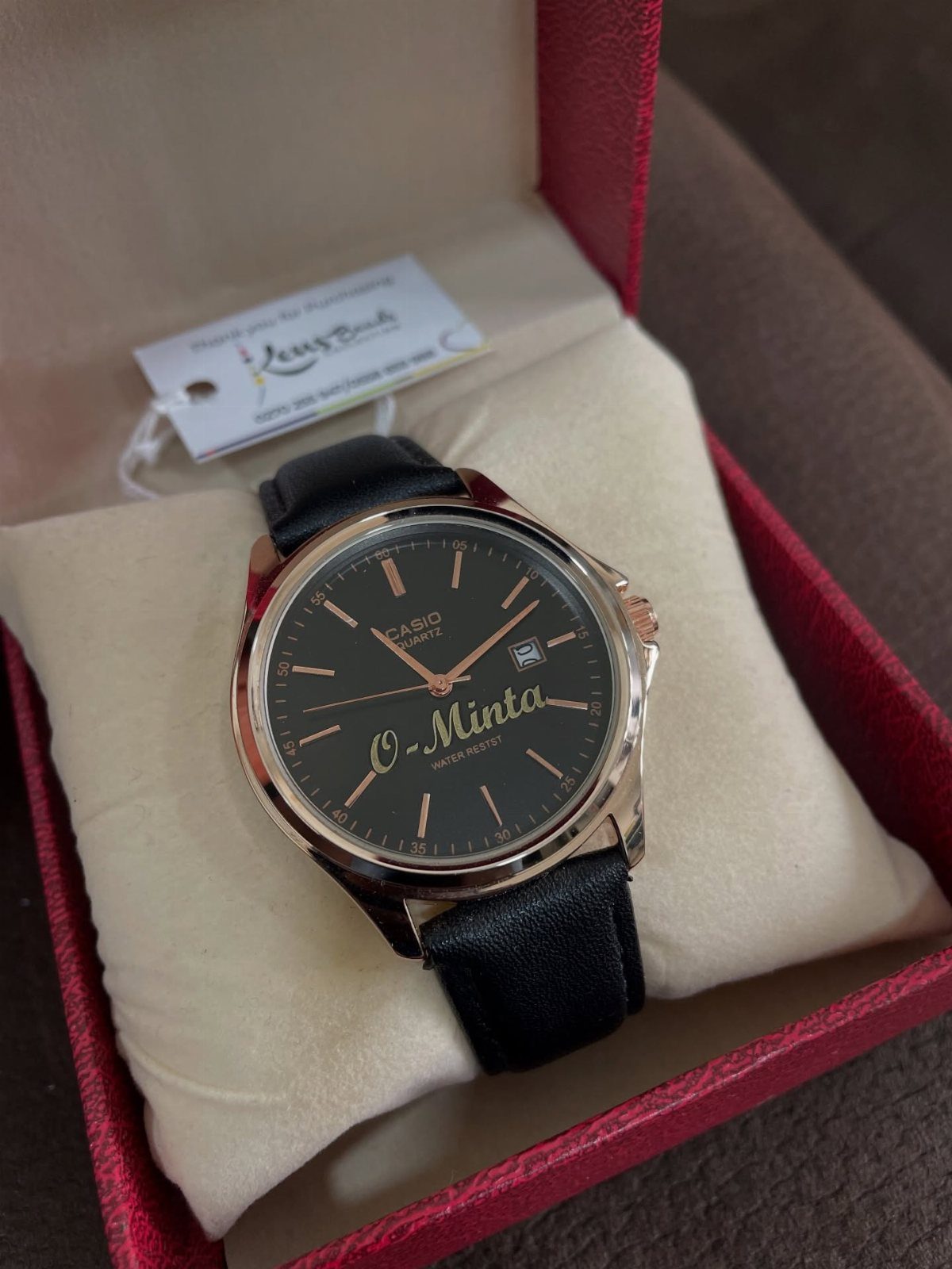 Casio quartz watch with personalized gold script on the face in a red box