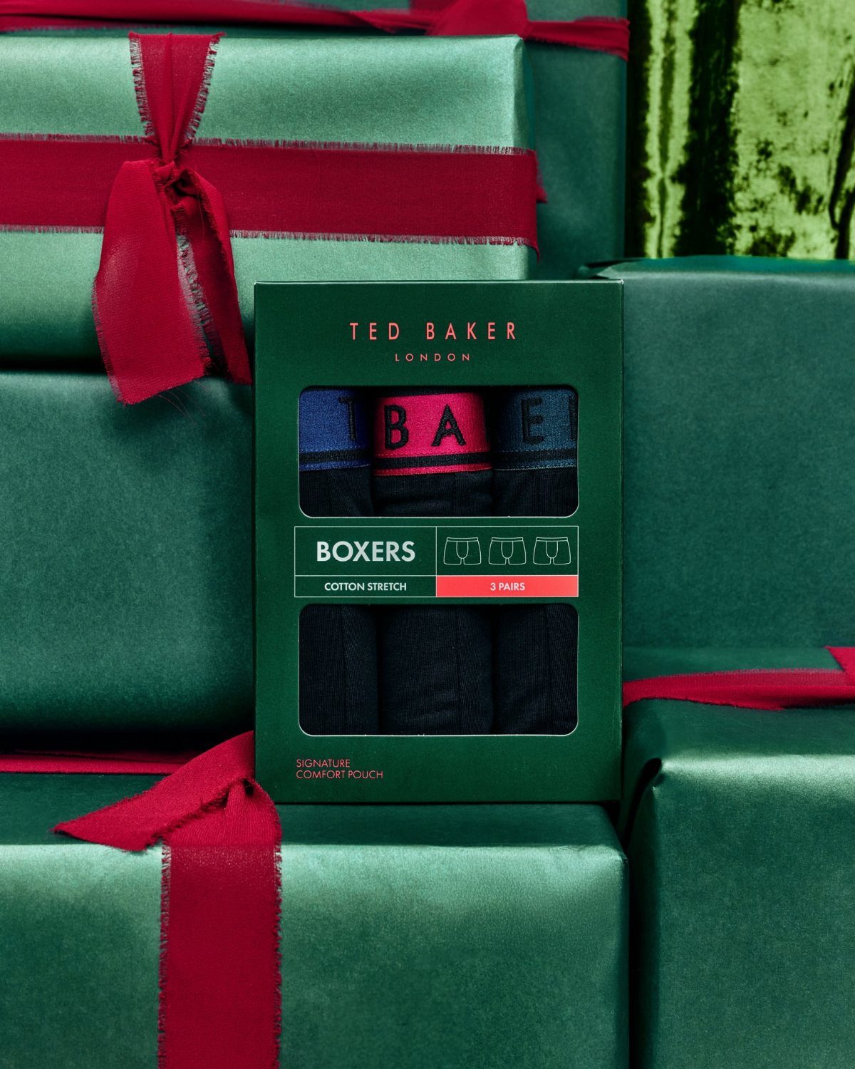 Ted Baker boxers in a green box surrounded by green wrapped Christmas gifts.