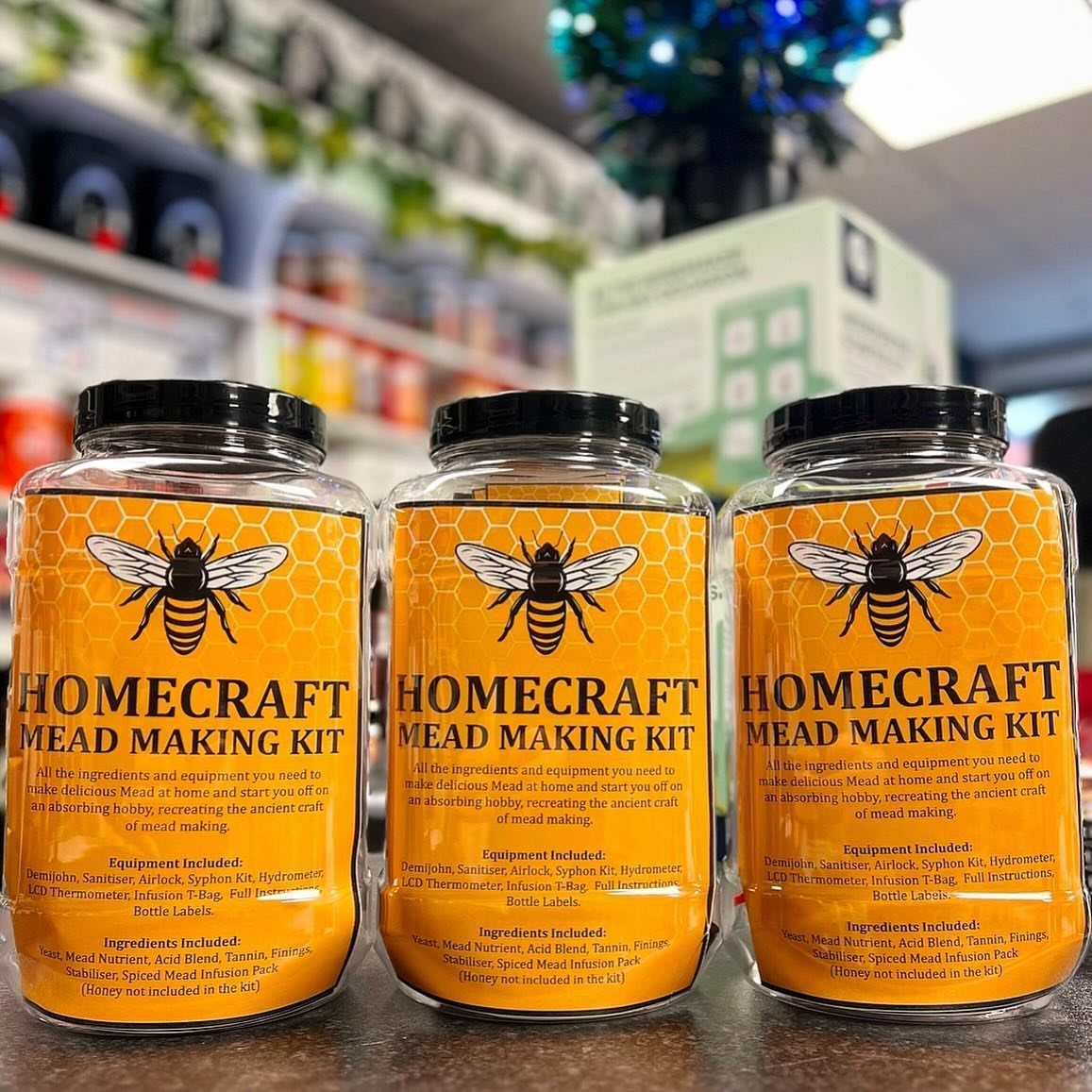 Three Homecraft Mead Making Kits in plastic jars with yellow bee labels.