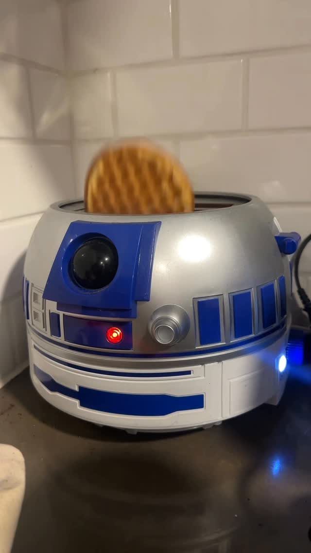 R2-D2 shaped waffle maker popping up a golden-brown waffle in a kitchen