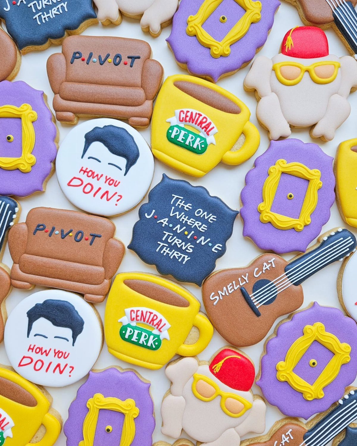 Decorated sugar cookies with Friends TV show themes and a birthday message.