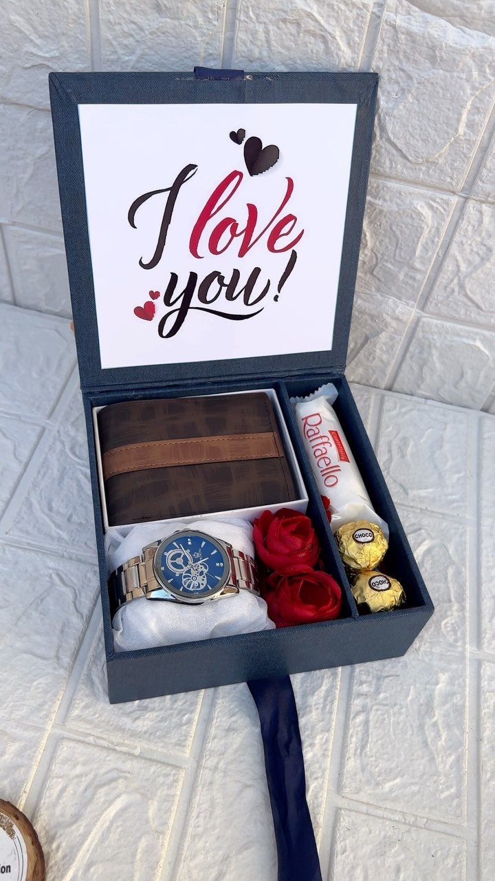 Gift box containing a watch, wallet, red roses, and chocolates for Valentine's Day.