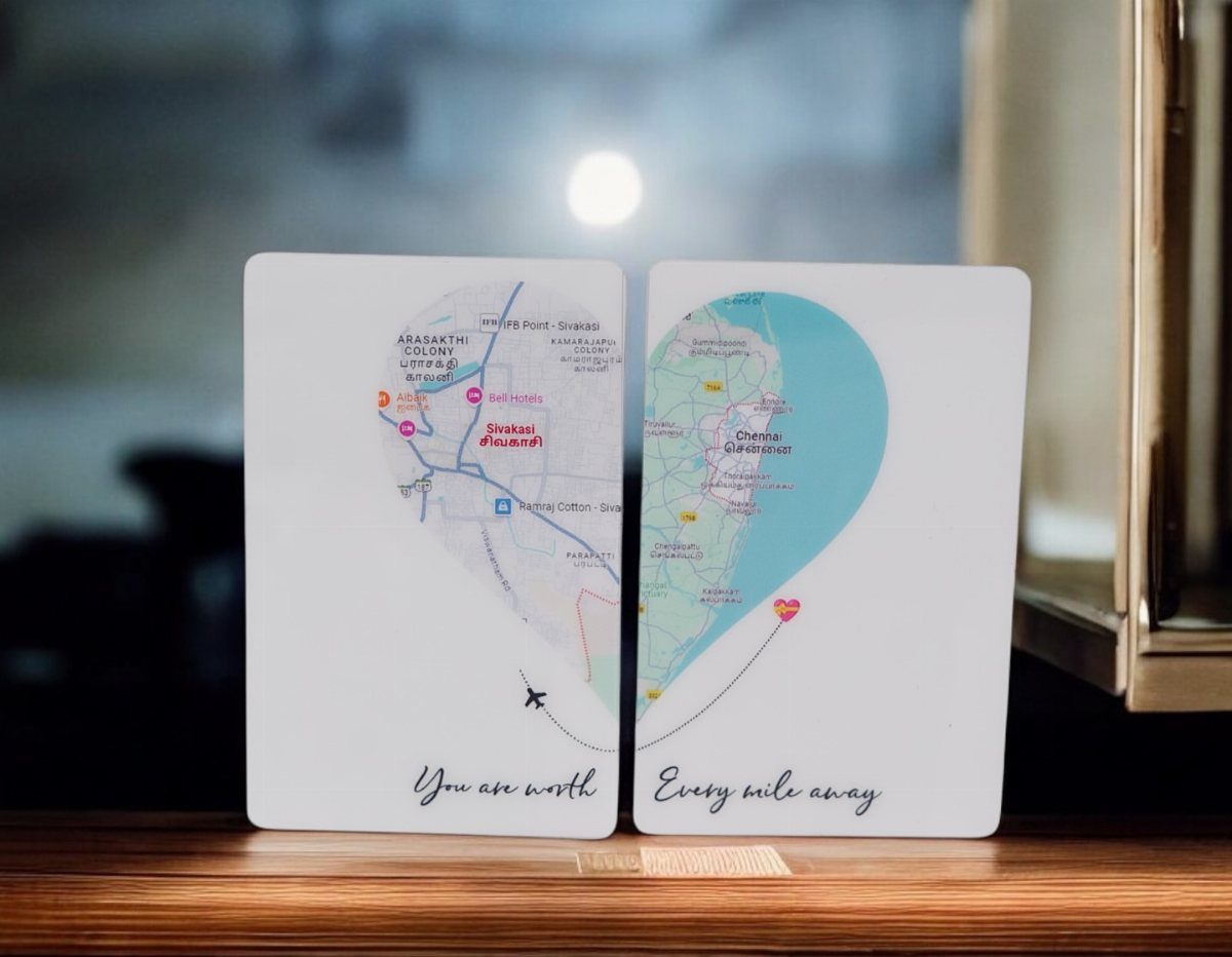 Two white plaques forming a heart-shaped map with a connecting airplane and heart.