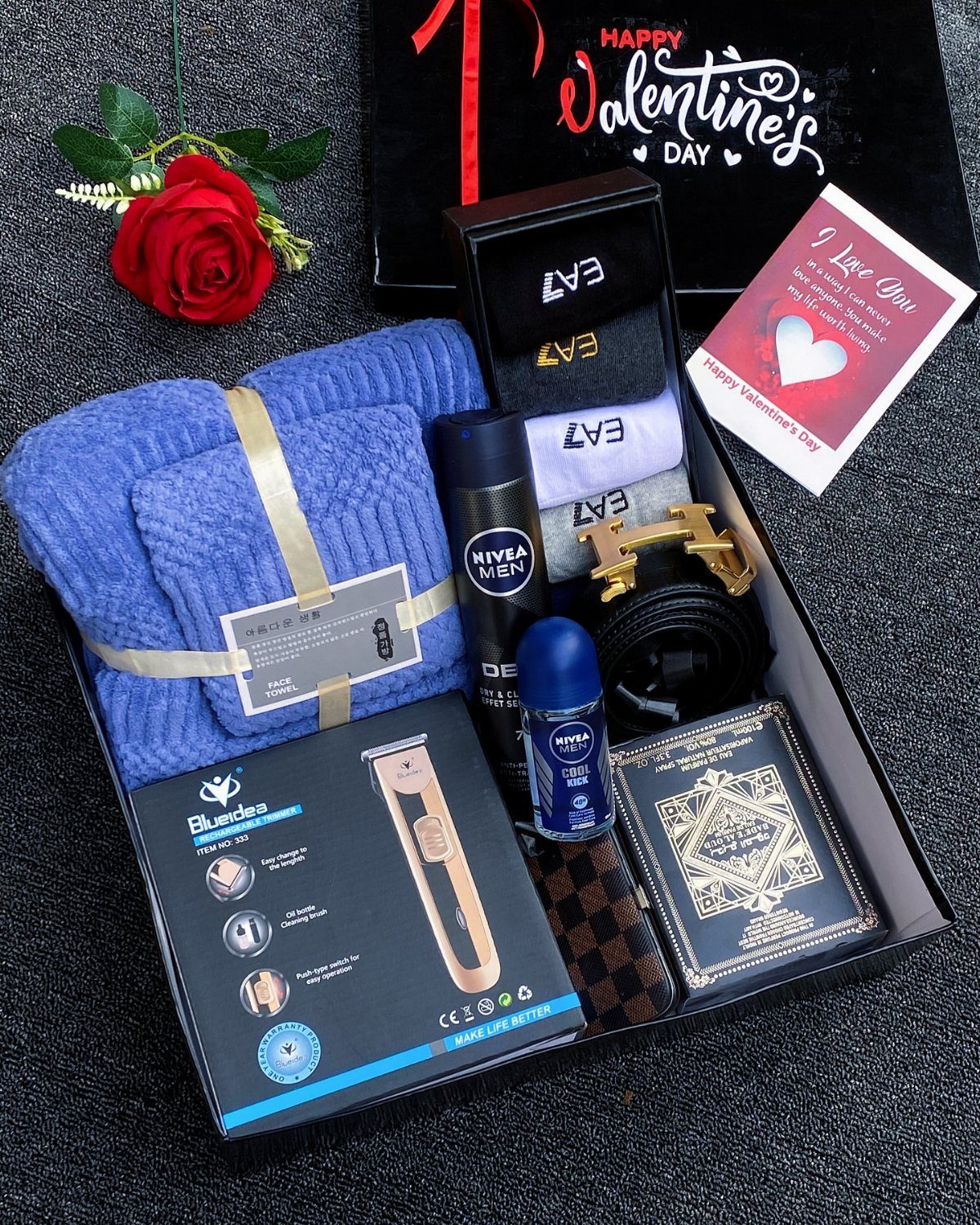 Grooming kit gift box with blue scarf, Nivea products, belt, and electric shaver.