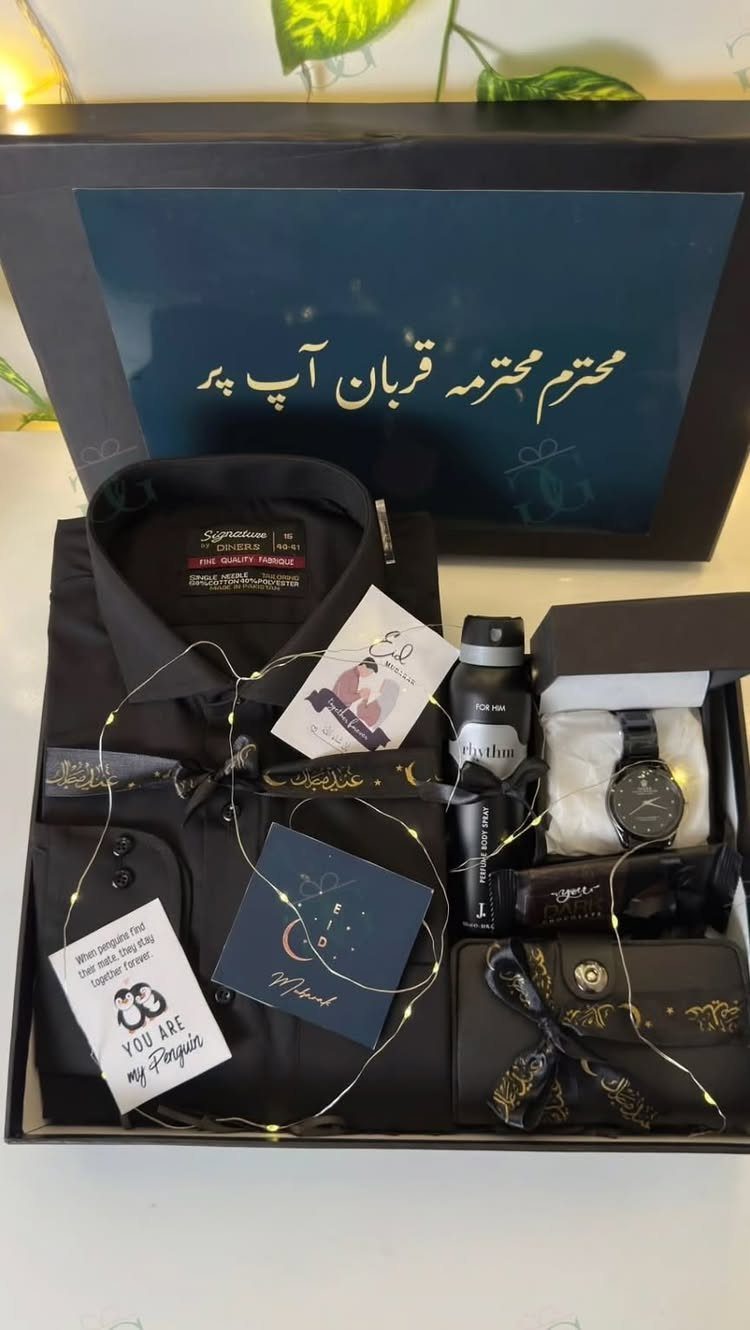 Black gift box with a dress shirt, watch, perfume, and fairy lights.