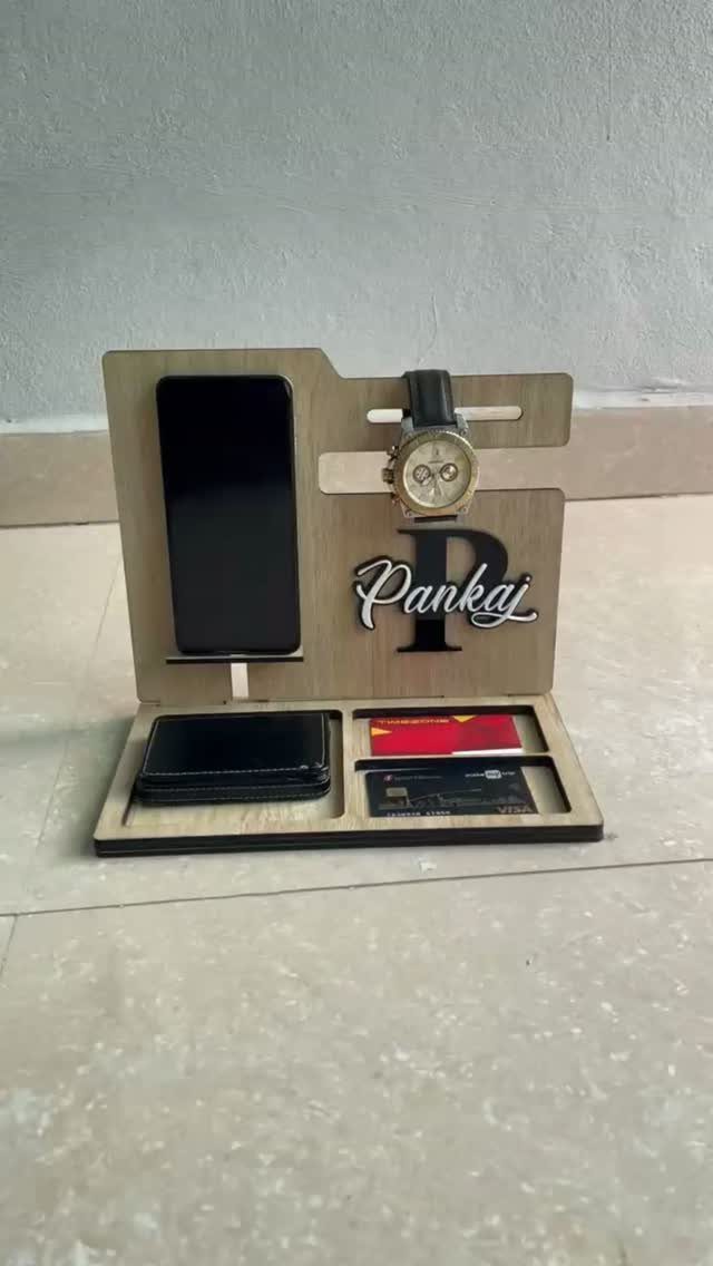 Personalized wooden docking station holding a phone, watch, wallet, and credit cards.