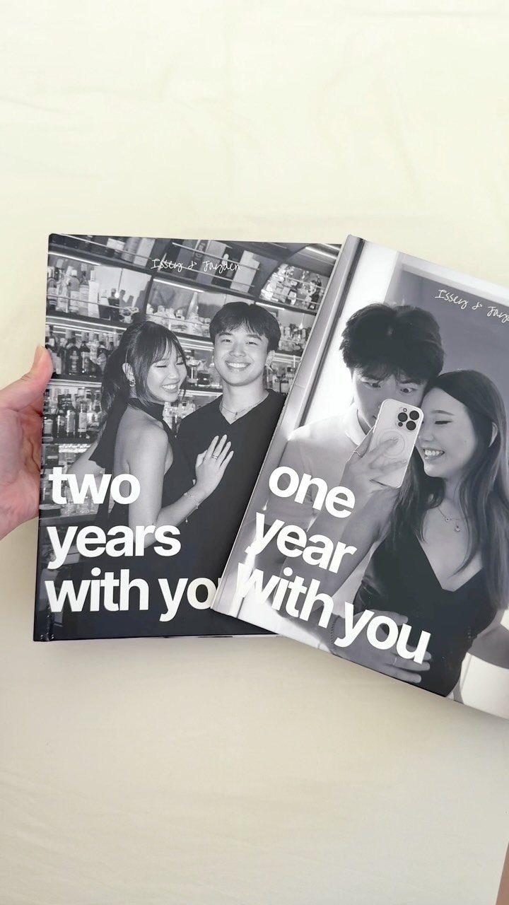 Two personalized photo books with black and white couple photos and anniversary text.