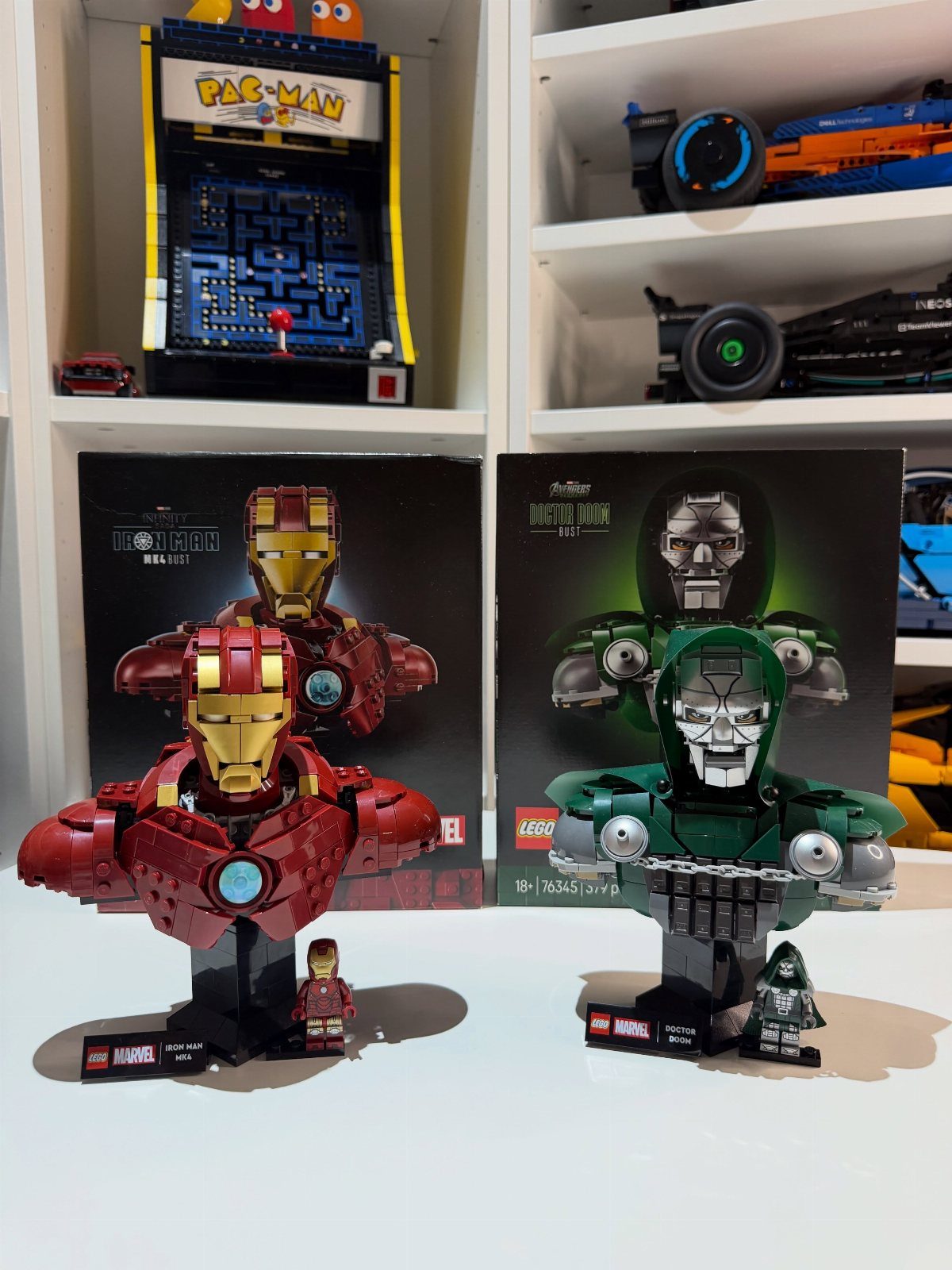 Lego busts of Iron Man and Doctor Doom displayed with their packaging boxes.