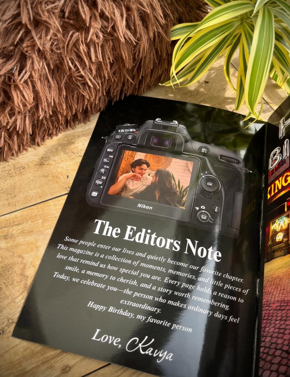 Personalized birthday magazine featuring a couple's photo on a camera screen with text.