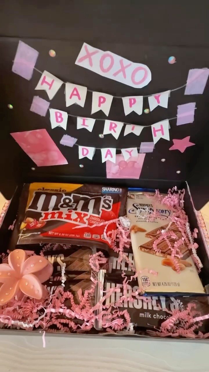 Birthday gift box with chocolates, pink shred, and a handmade Happy Birthday banner.