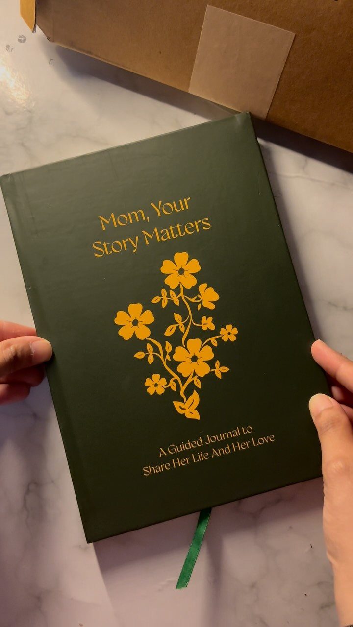 Dark green guided journal for mothers with gold floral design and text.