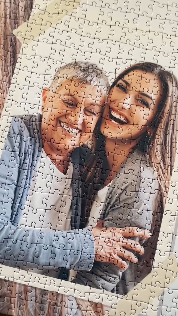 Jigsaw puzzle depicting a smiling older man and woman hugging closely.