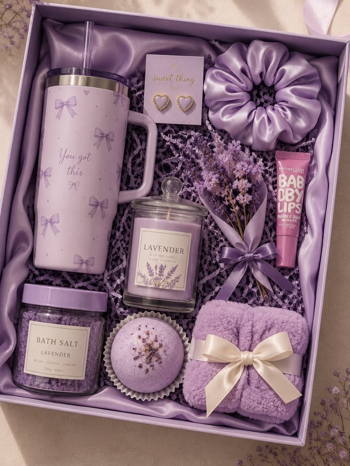 Lavender-themed relaxation gift set in a purple box with spa accessories and candle.