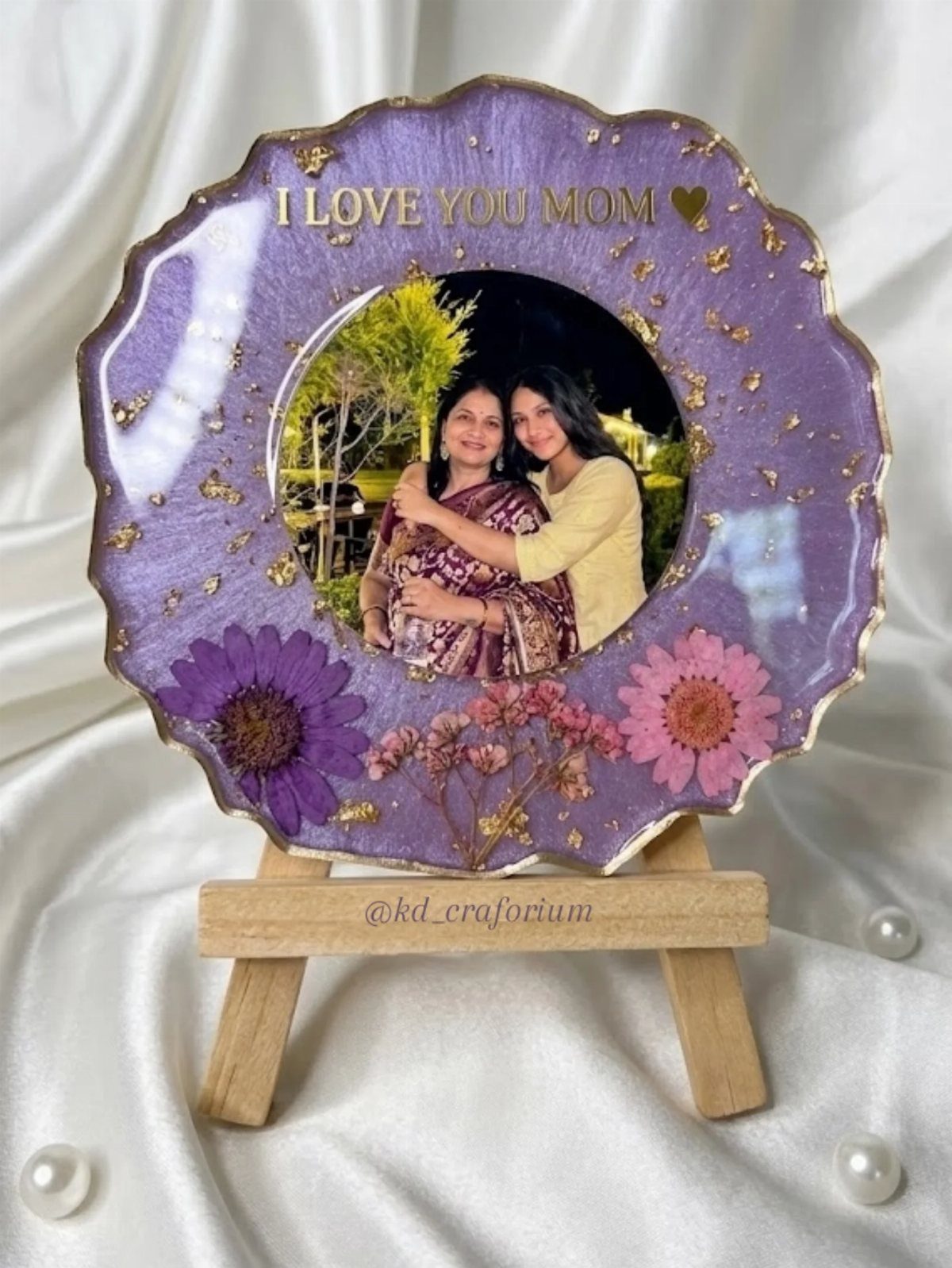 Purple resin photo plaque with gold edges and dried flowers on wooden easel
