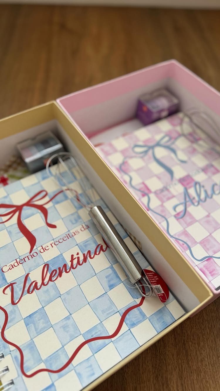 Two personalized recipe notebooks with checkered covers and a whisk in a gift box.
