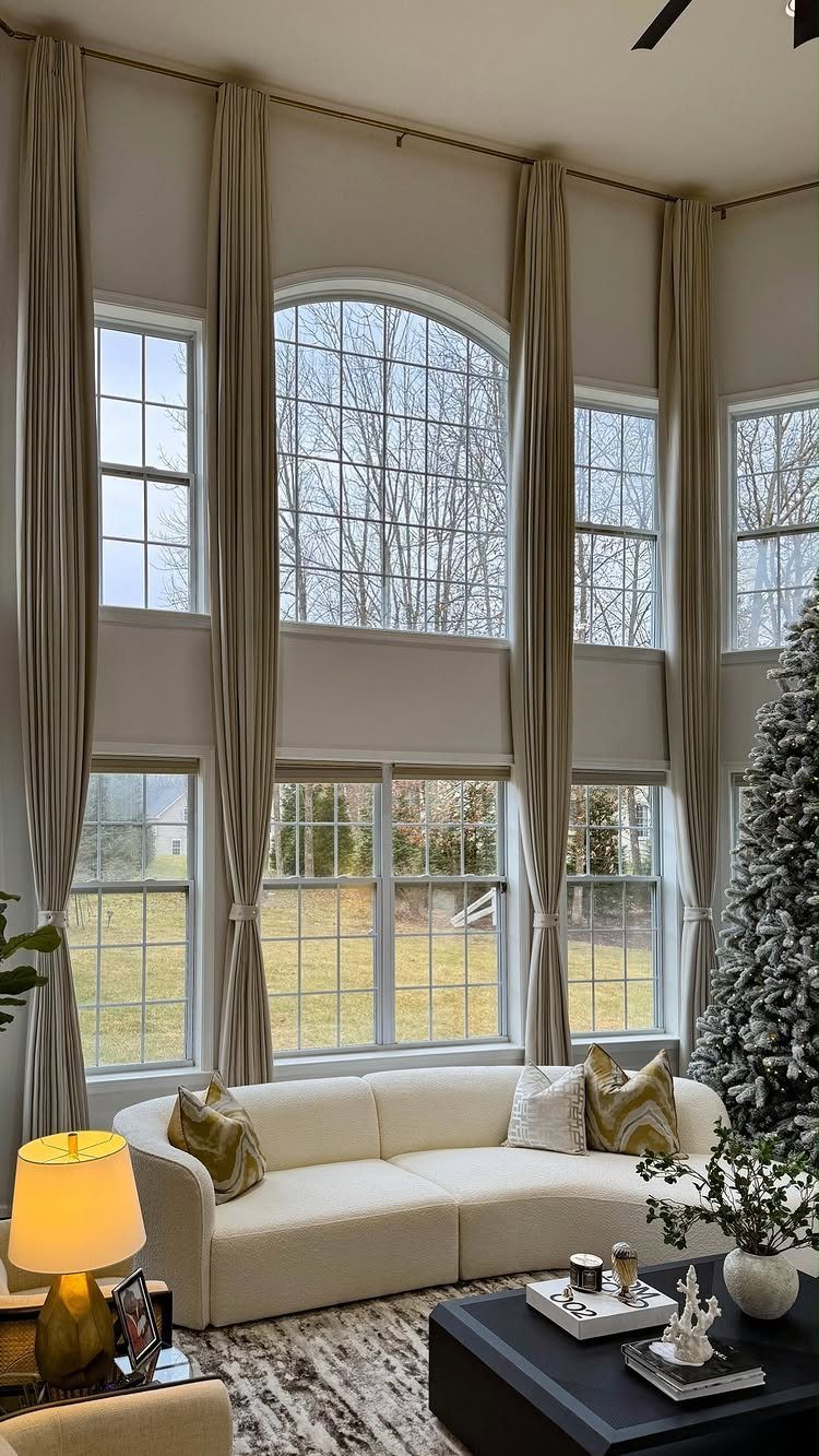 White sofa and flocked Christmas tree in a neutral toned living room