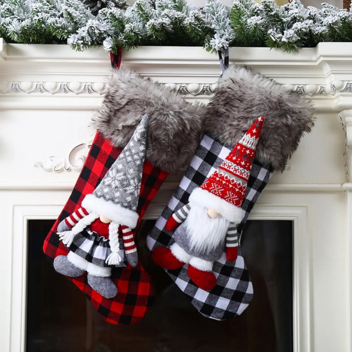 Plaid Christmas stockings with gnome figures hanging from a white fireplace mantel