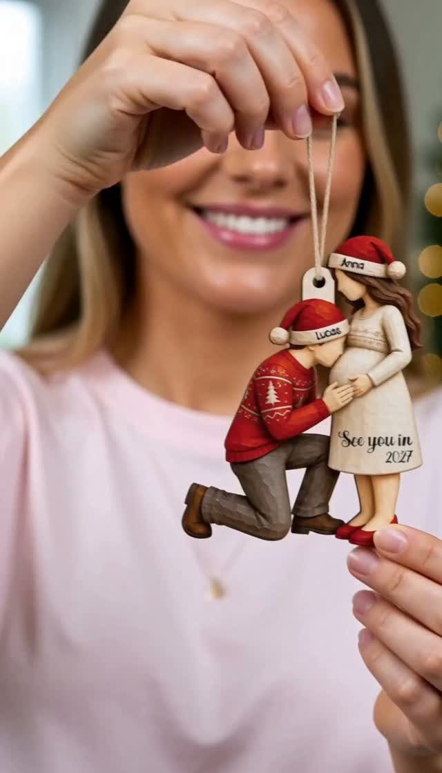 Personalized Christmas ornament showing a couple celebrating a pregnancy with a 2027 date.