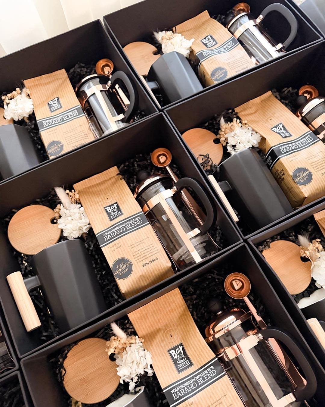 Coffee gift sets in black boxes with French presses and Barano Blend coffee.